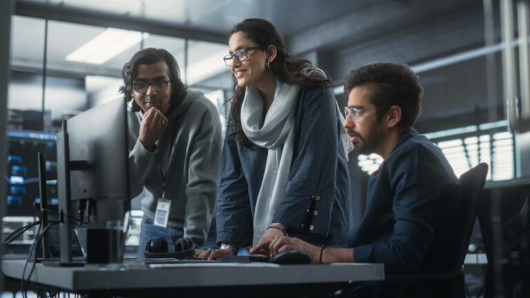 Team looking at computer on desk