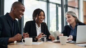 Business team at conference table smiling