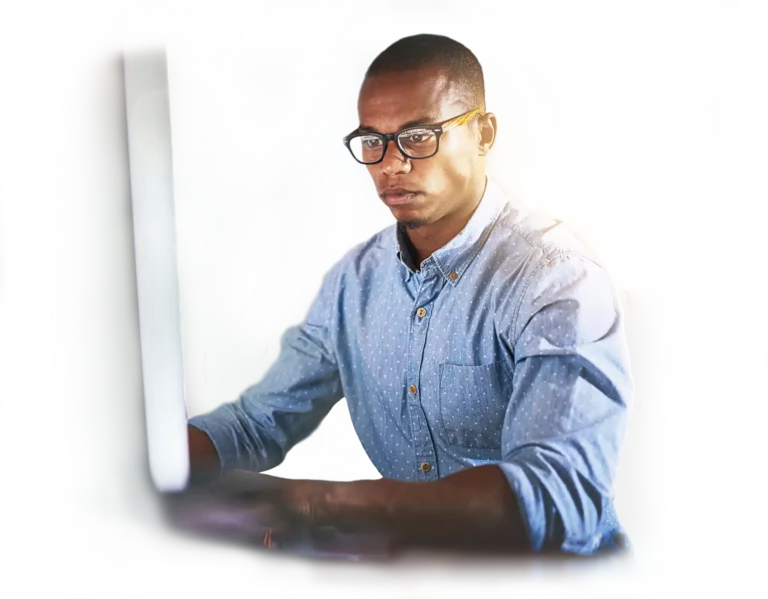 African American programmer working on desktop supporting a cloud migration